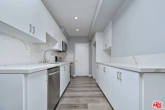 a kitchen with cabinets and sink