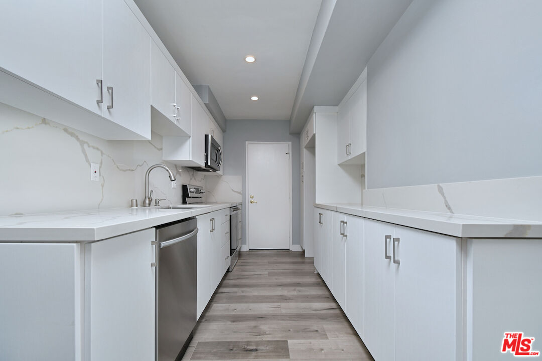 2345 Roscomare Road, Unit 205 Los Angeles, CA 90077 - Photo 16 of 50 a kitchen with cabinets and sink
