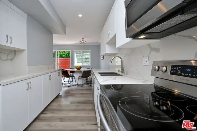 a kitchen with a stove and a sink