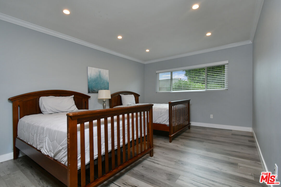 2345 Roscomare Road, Unit 205 Los Angeles, CA 90077 - Photo 25 of 50 a bedroom with two beds and a window