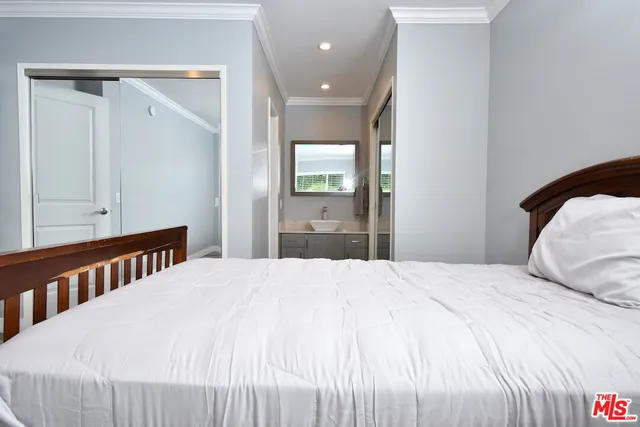 a bedroom with a bed and a mirror