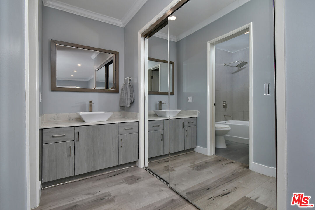 2345 Roscomare Road, Unit 205 Los Angeles, CA 90077 - Photo 28 of 50 a spacious bathroom with a double vanity sink a toilet and a shower
