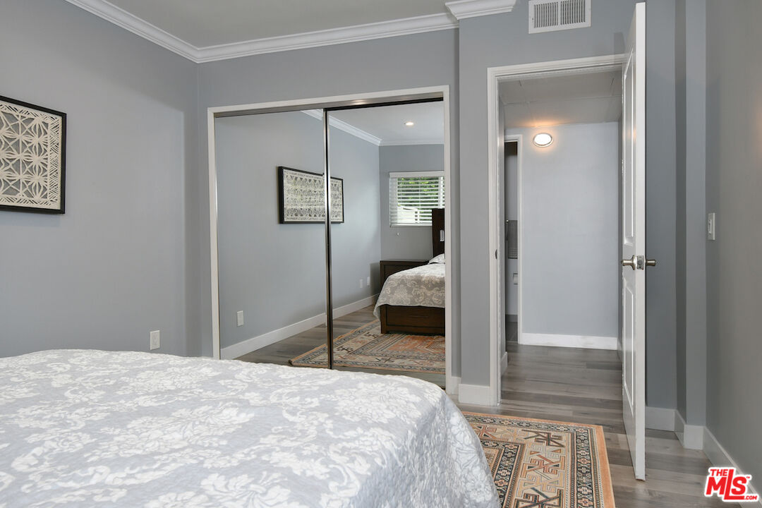 2345 Roscomare Road, Unit 205 Los Angeles, CA 90077 - Photo 33 of 50 a bedroom with a bed and glass door