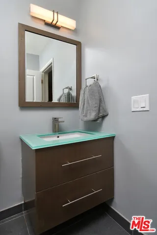 a bathroom with a sink and a mirror
