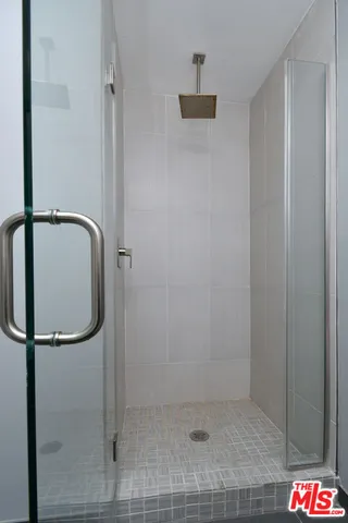 a bathroom with a glass shower door