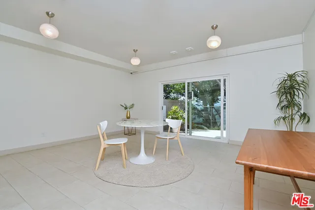 a work room with furniture and a potted plant