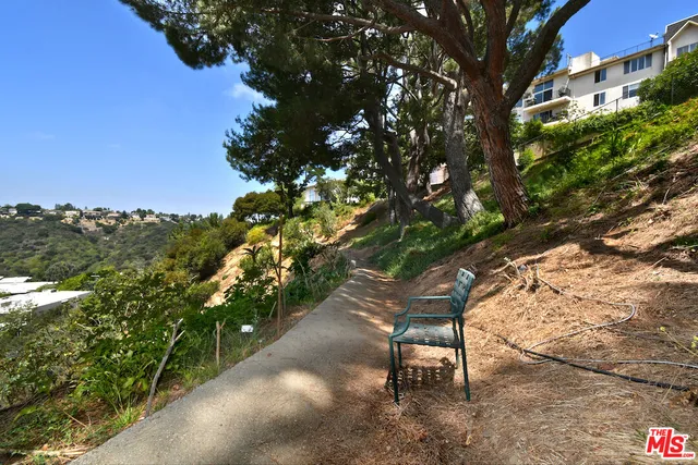 a wooden bench sitting in middle of a yard