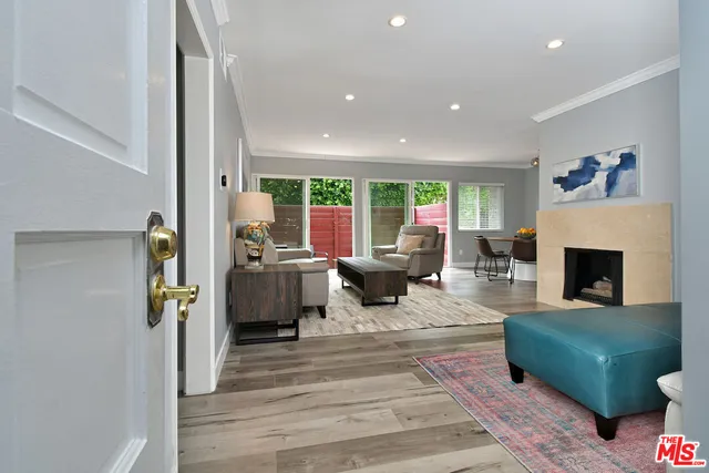 a living room with furniture large window and a fireplace