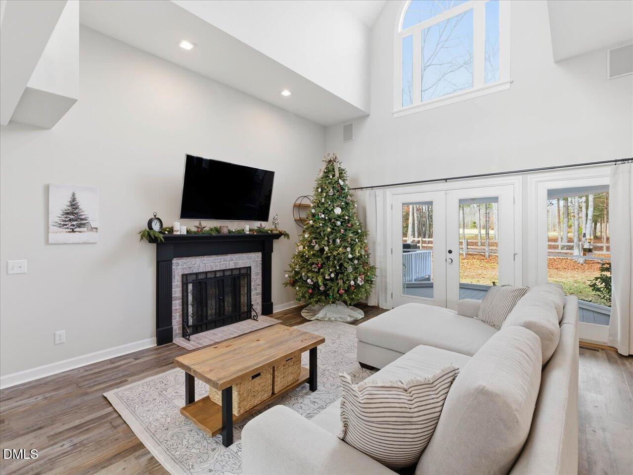 274 Powers Country Lane Bennett, NC 27208 - Photo 11 of 62 a living room with furniture a flat screen tv and a fireplace