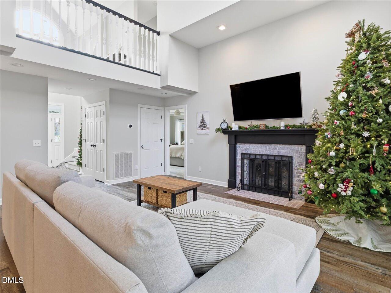 274 Powers Country Lane Bennett, NC 27208 - Photo 12 of 62 a living room with furniture a flat screen tv and a fireplace