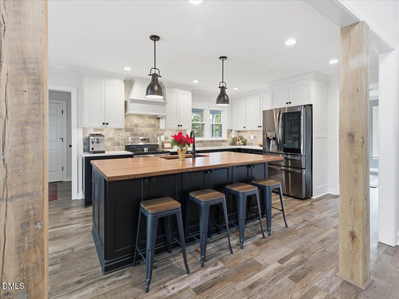 274 Powers Country Lane Bennett, NC 27208 - Photo 14 of 62 a kitchen with a sink and chairs