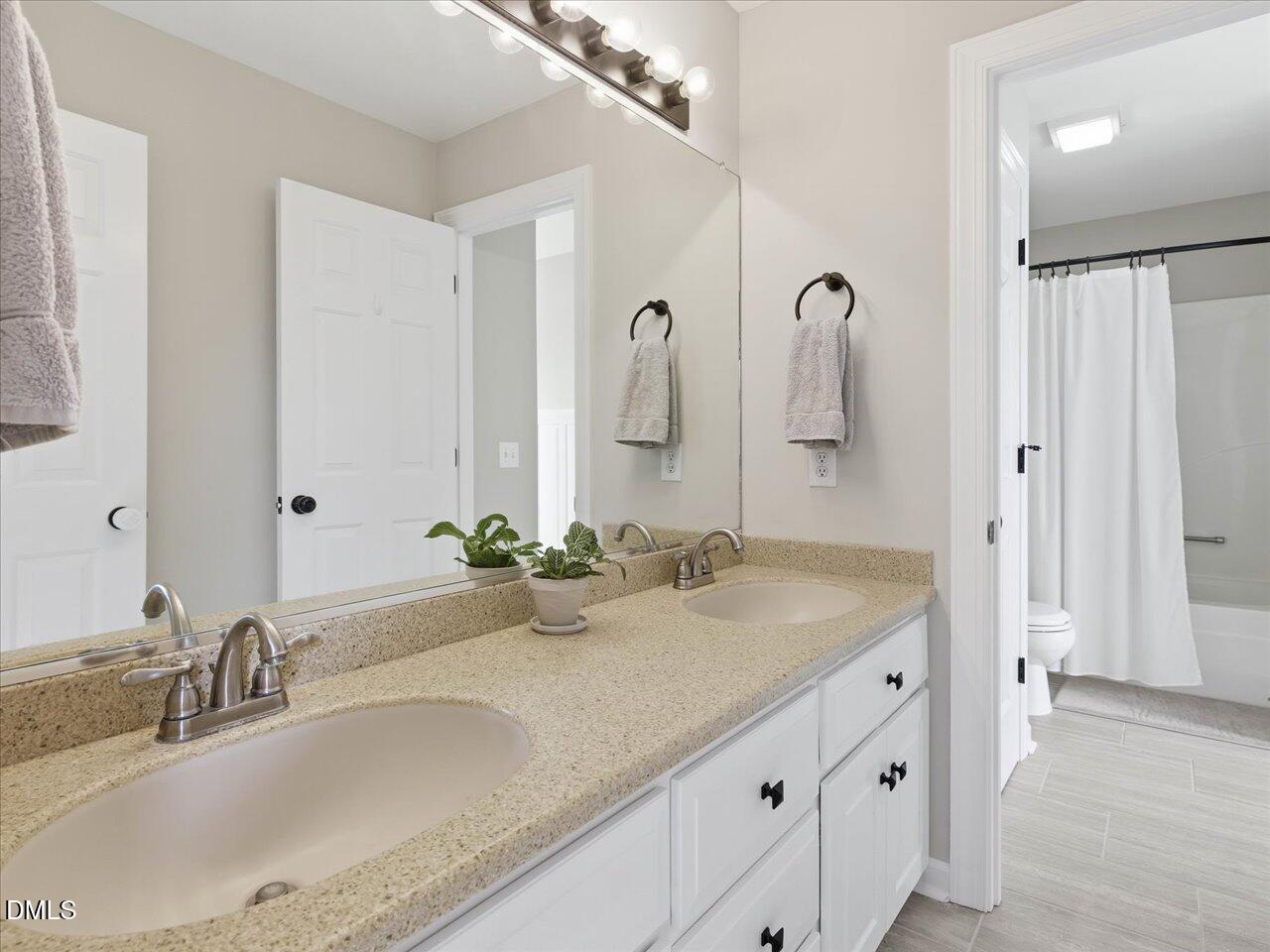 274 Powers Country Lane Bennett, NC 27208 - Photo 33 of 62 a bathroom with a granite countertop sink and a mirror