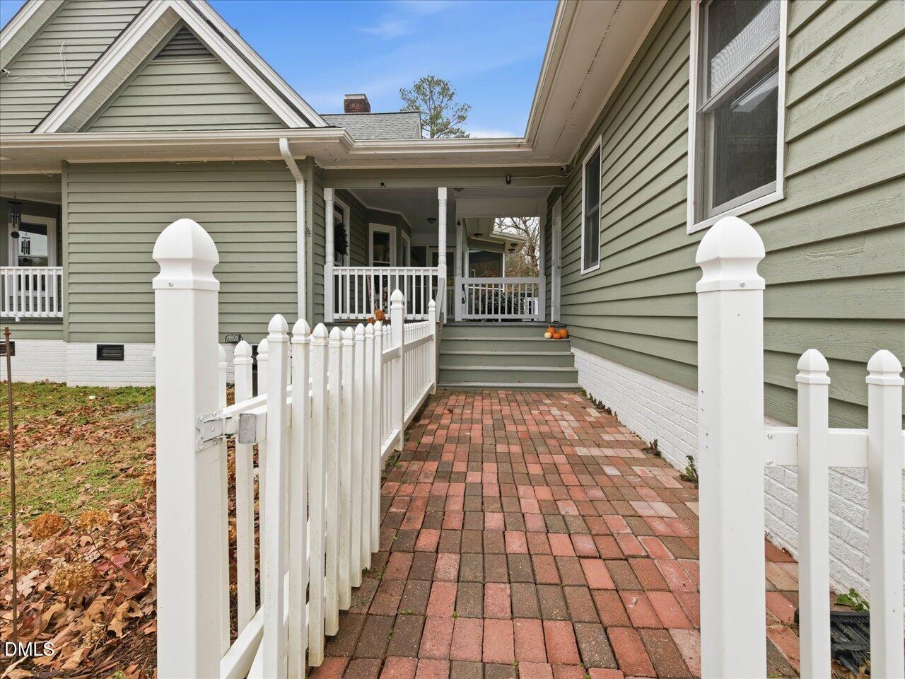 274 Powers Country Lane Bennett, NC 27208 - Photo 43 of 62 a front view of a house with a porch