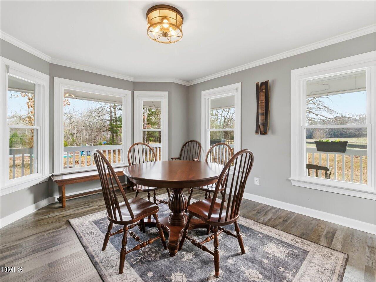 274 Powers Country Lane Bennett, NC 27208 - Photo 10 of 62 a view of a dining room with furniture a couch and wooden floor