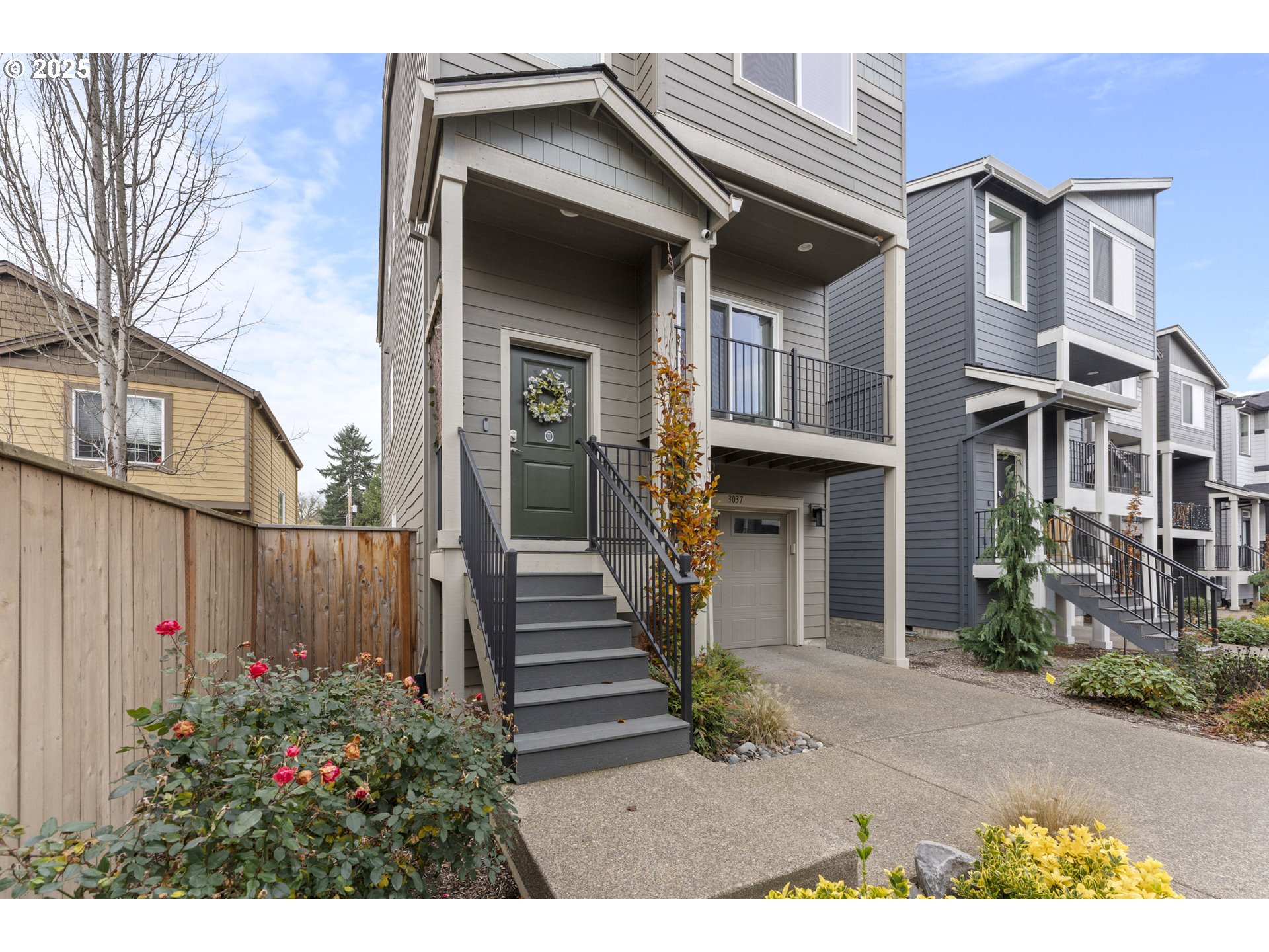 3037 Southwest Sherman Place Beaverton, OR 97003 - Photo 4 of 39 a view of a house with a small yard and plants