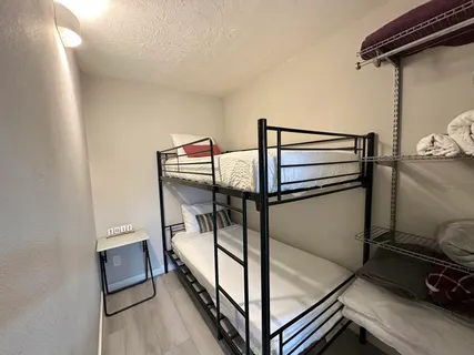 a bedroom with a bed and a mirror