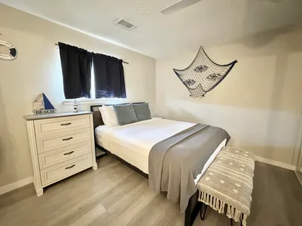 a bedroom with two beds and a table