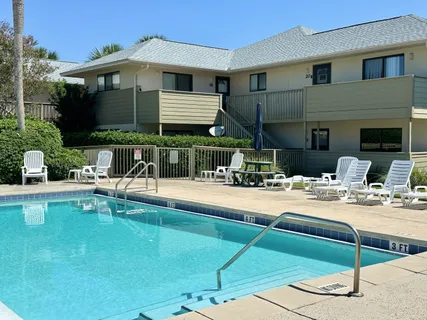 a view of a house with swimming pool and sitting area