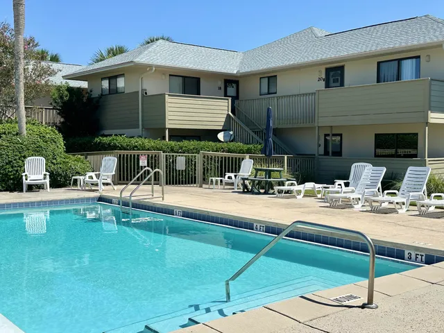 a view of a house with swimming pool and sitting area