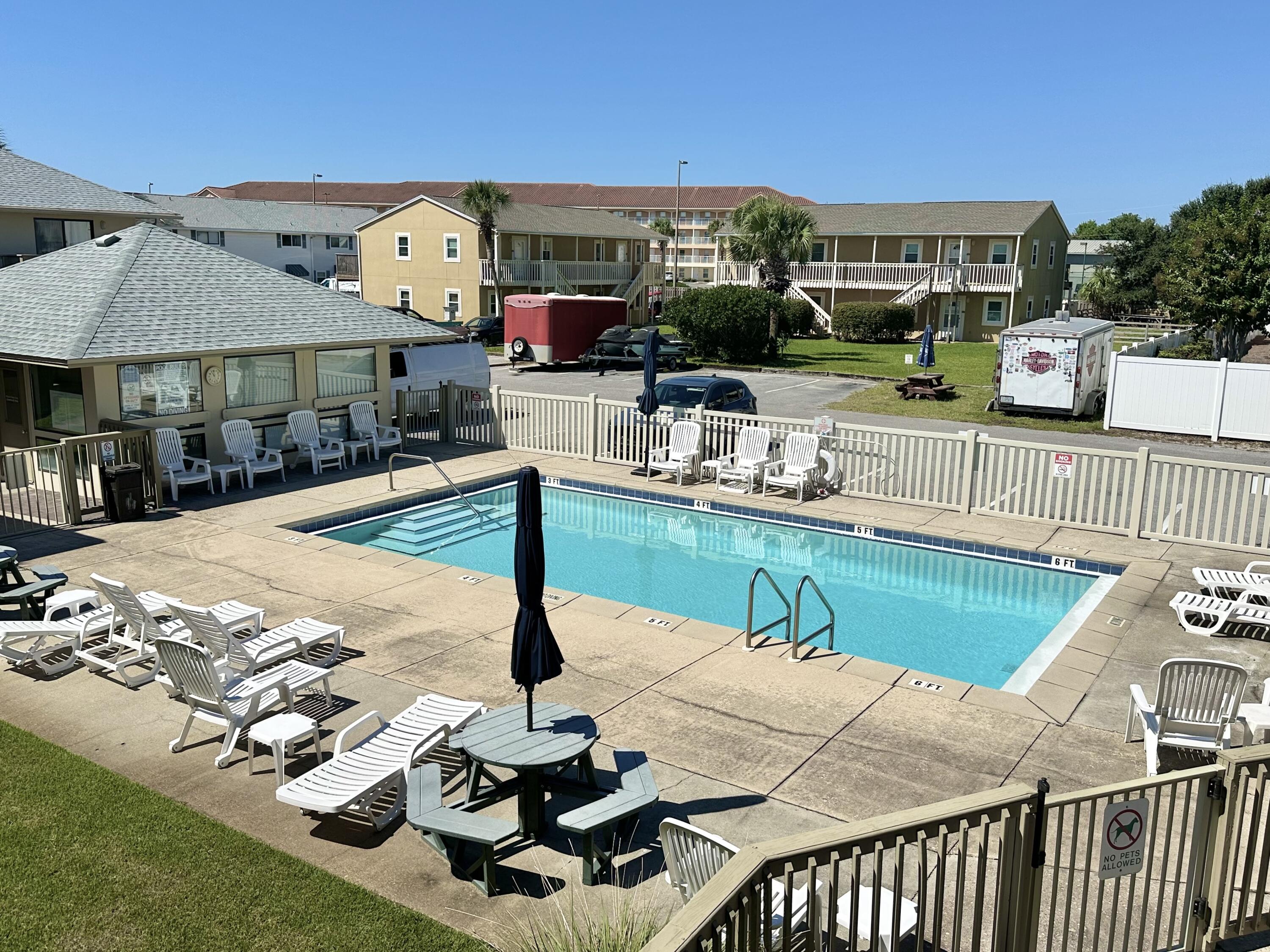 64 Cross Creek Road, Unit 20C Miramar Beach, FL 32550 - Photo 6 of 28 a roof deck with table and chairs potted plants