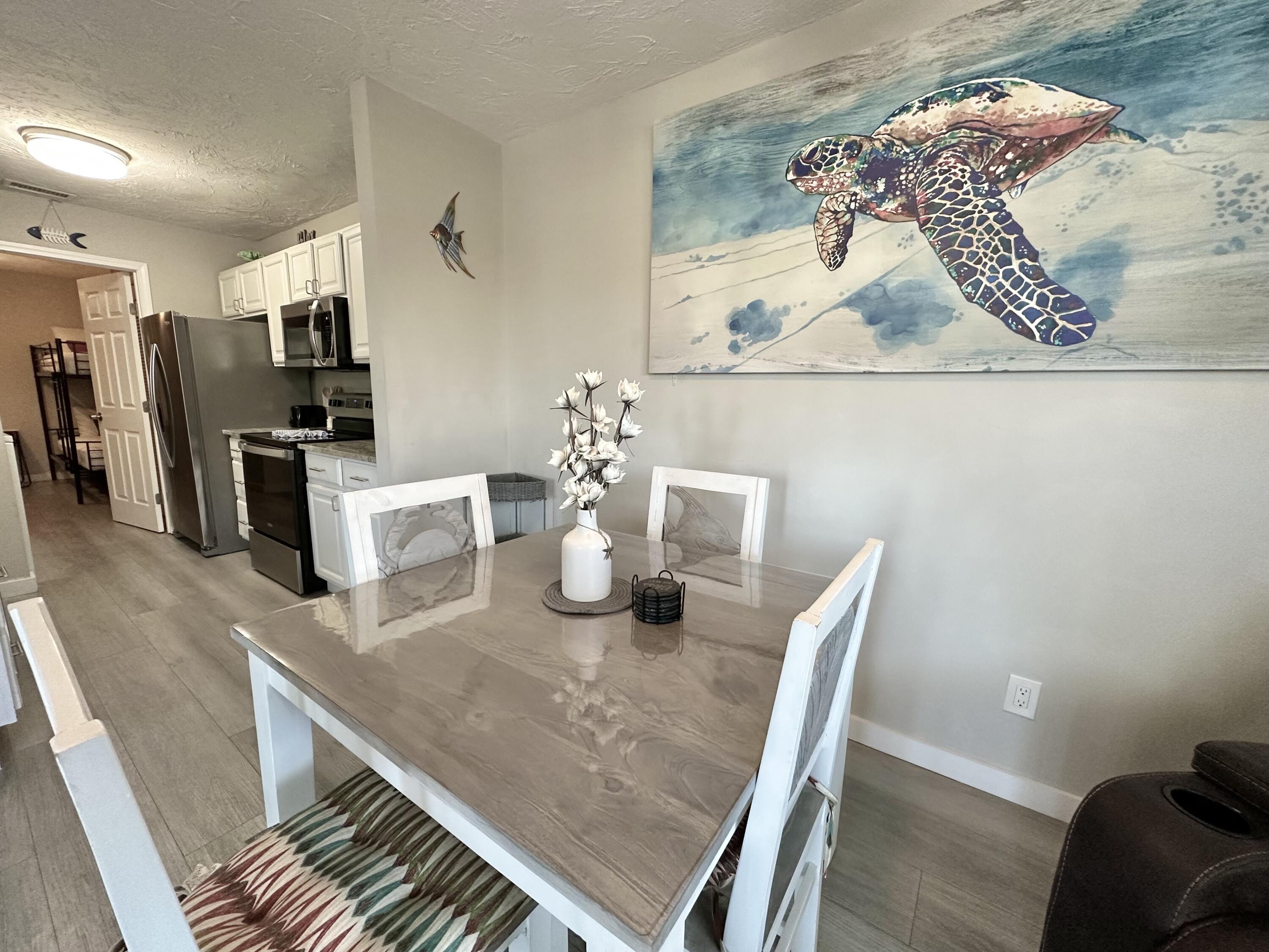 64 Cross Creek Road, Unit 20C Miramar Beach, FL 32550 - Photo 10 of 28 a dining room with furniture and wooden floor