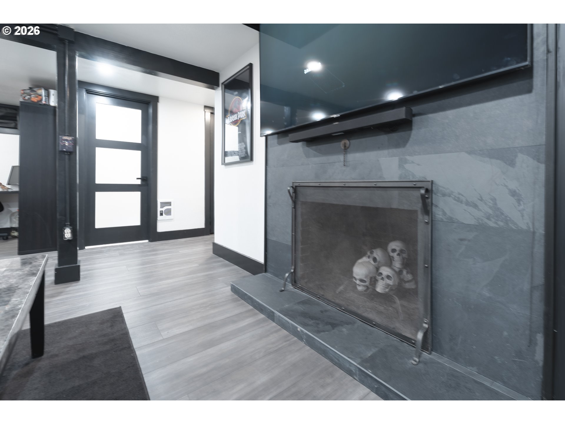 153 Southeast James Street Camas, WA 98607 - Photo 27 of 35 a view of an empty room with wooden floor and a fireplace