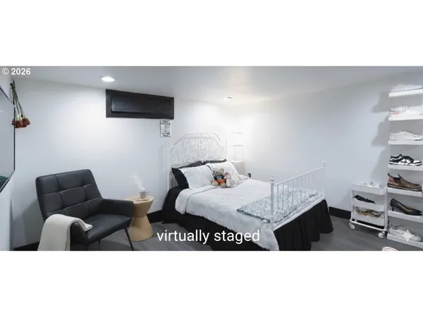 a bedroom with furniture and a wooden floor