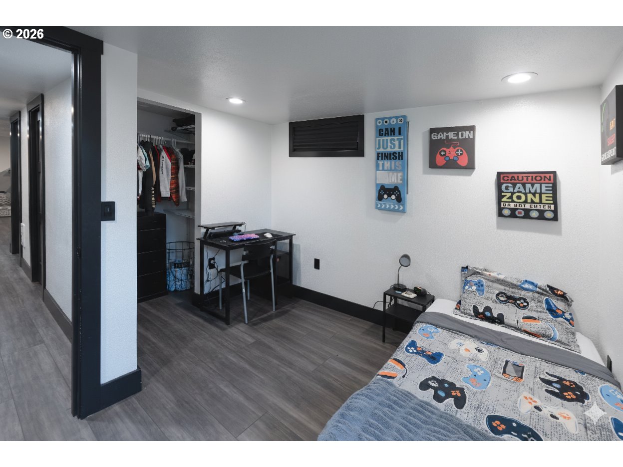 153 Southeast James Street Camas, WA 98607 - Photo 30 of 35 a bedroom with furniture and a wooden floor