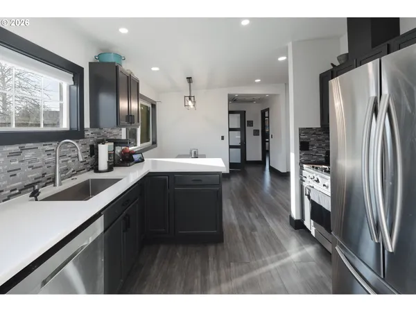 a kitchen with stainless steel appliances a refrigerator and a stove