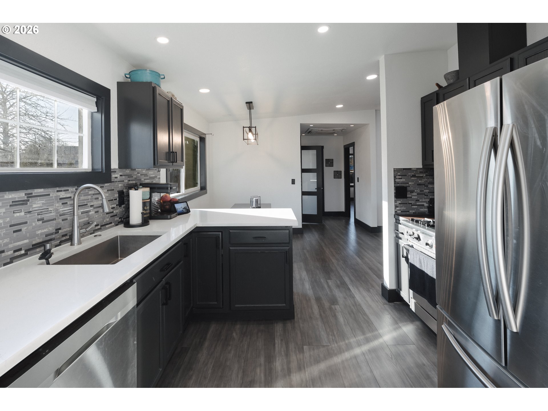 153 Southeast James Street Camas, WA 98607 - Photo 6 of 35 a kitchen with stainless steel appliances a sink cabinets and a wooden floor