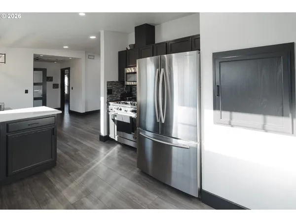 a kitchen with stainless steel appliances granite countertop a sink stove and cabinets