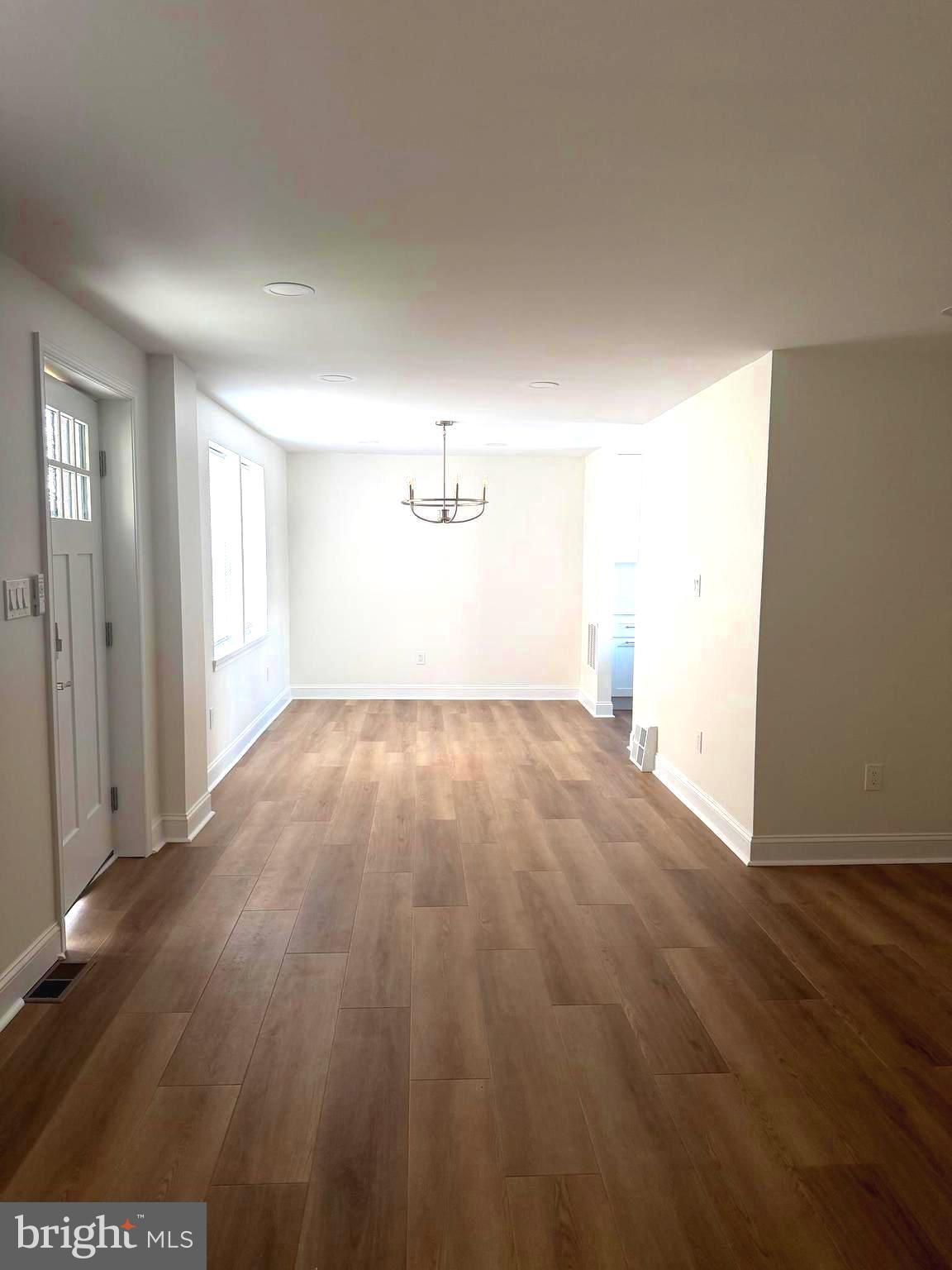 306 Brentwood Road Havertown, PA 19083 - Photo 13 of 48 an empty room with wooden floor and windows
