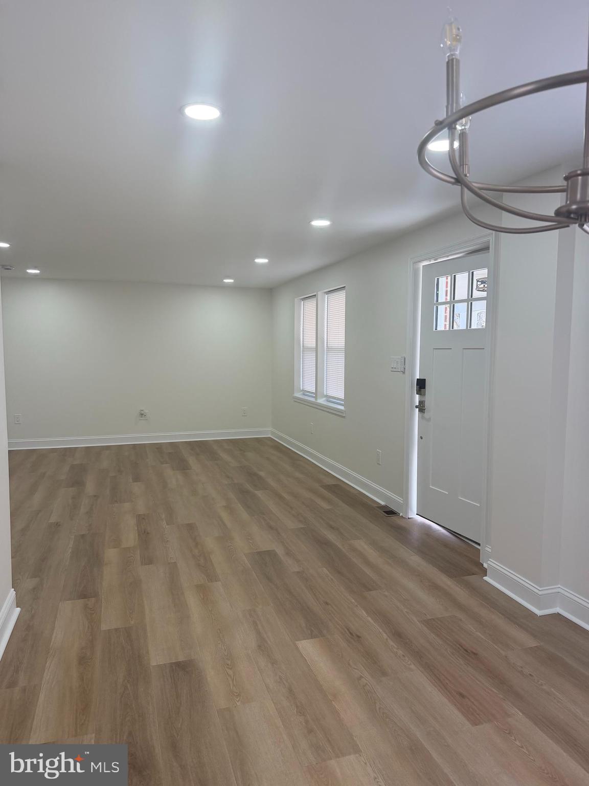 306 Brentwood Road Havertown, PA 19083 - Photo 18 of 48 an empty room with wooden floor and windows