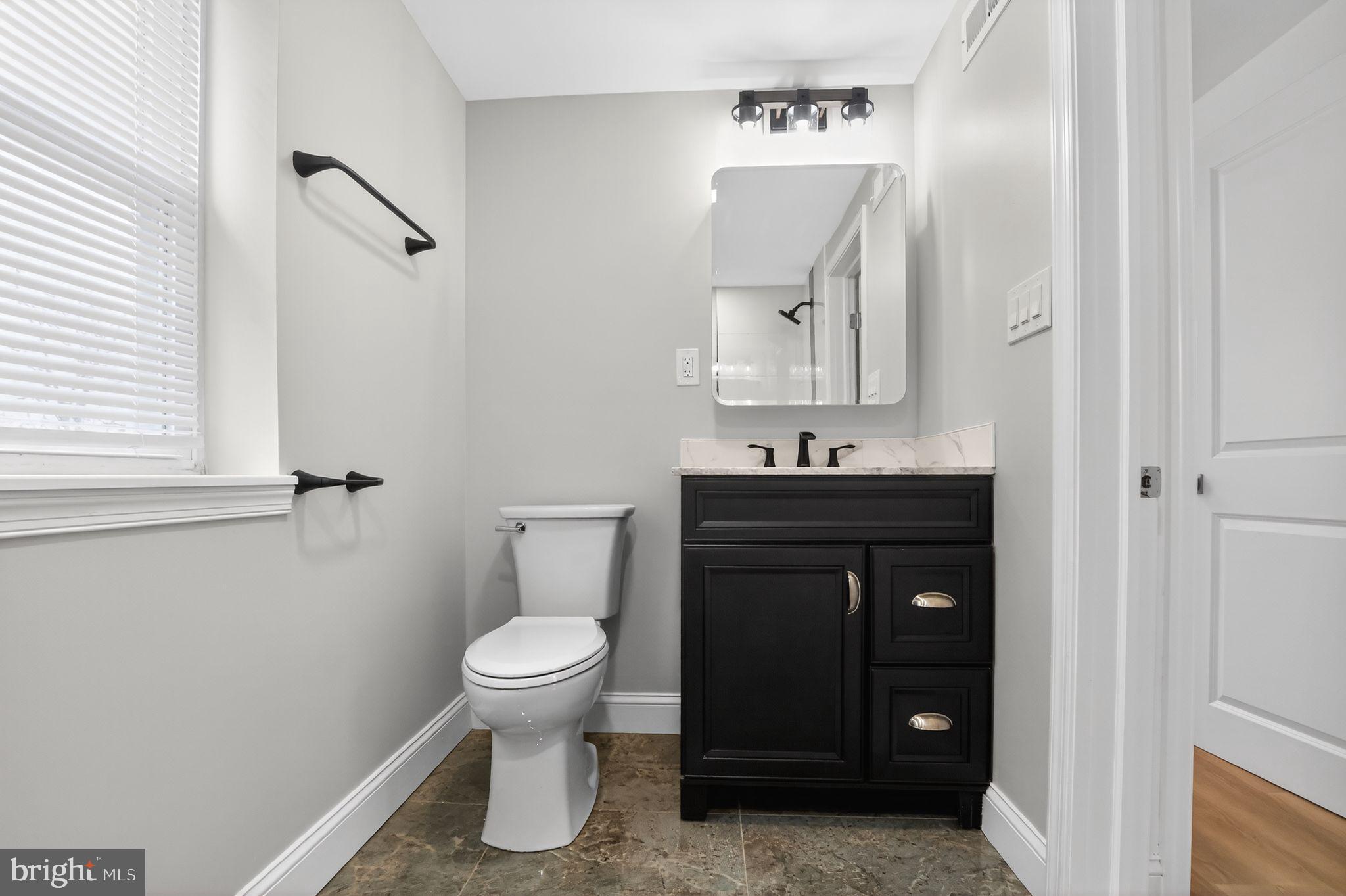 306 Brentwood Road Havertown, PA 19083 - Photo 19 of 48 a bathroom with a toilet a sink and mirror