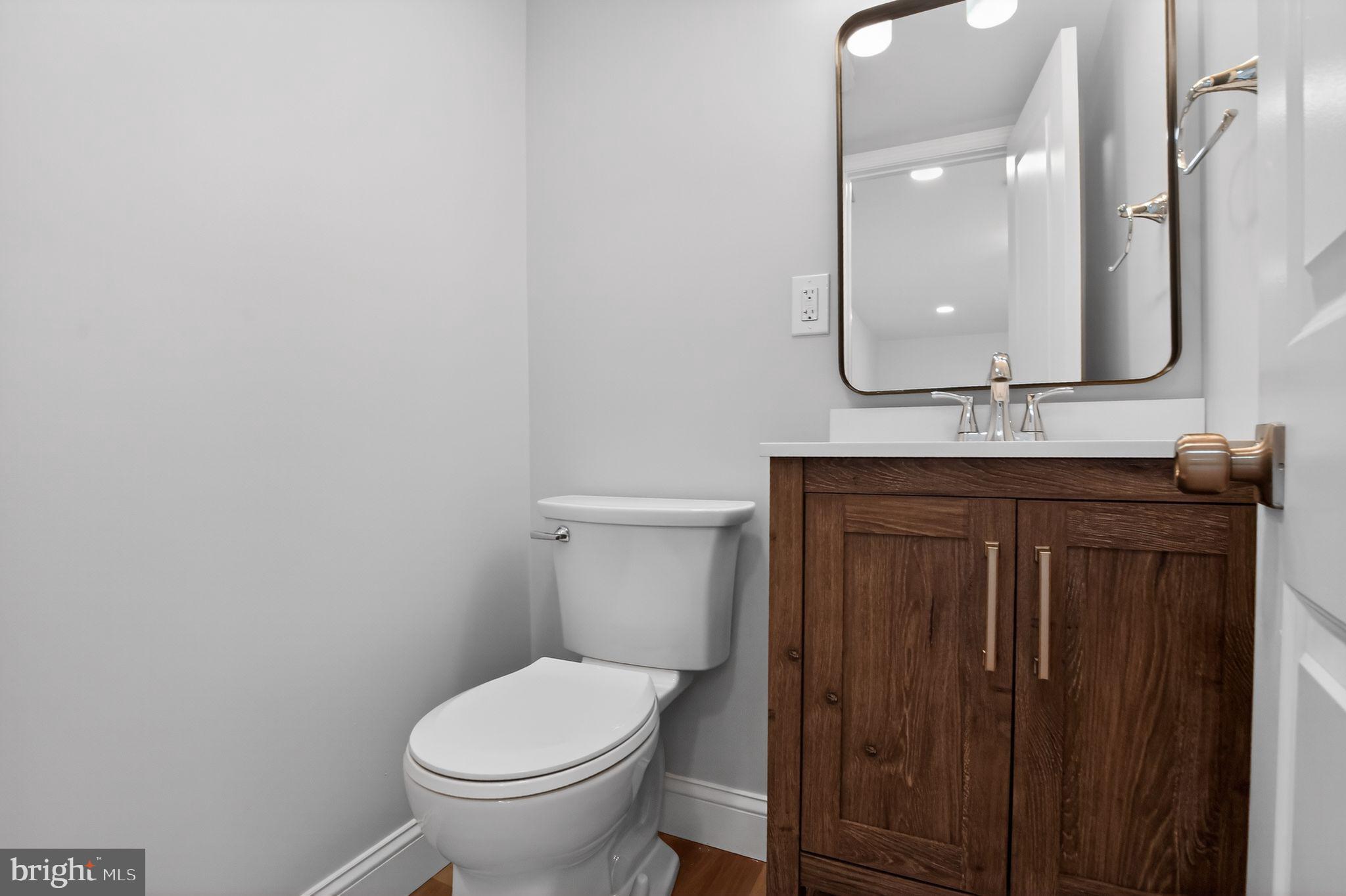 306 Brentwood Road Havertown, PA 19083 - Photo 28 of 48 a bathroom with a granite countertop toilet sink and mirror