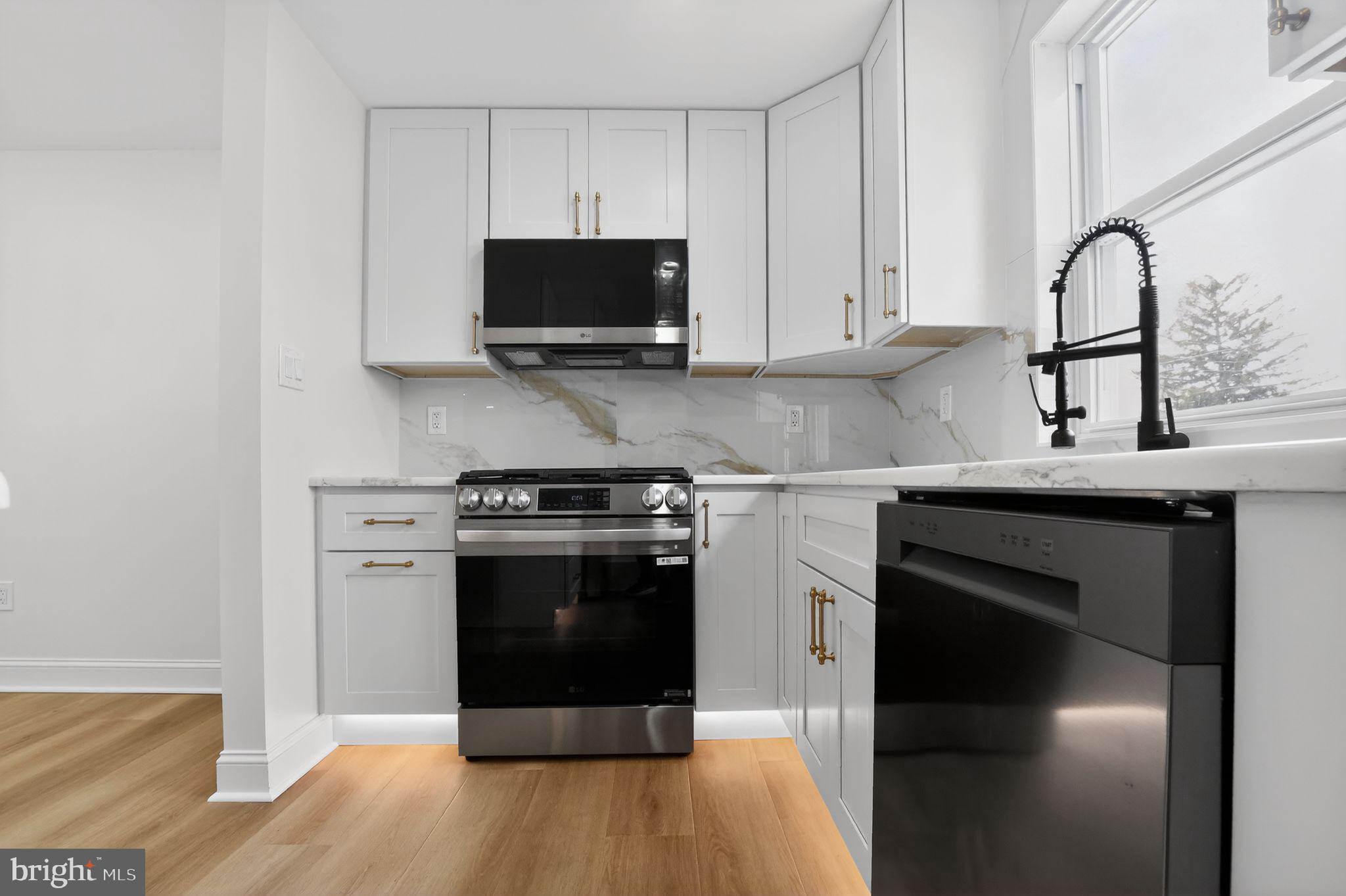 306 Brentwood Road Havertown, PA 19083 - Photo 4 of 48 a kitchen with stainless steel appliances a stove microwave and sink