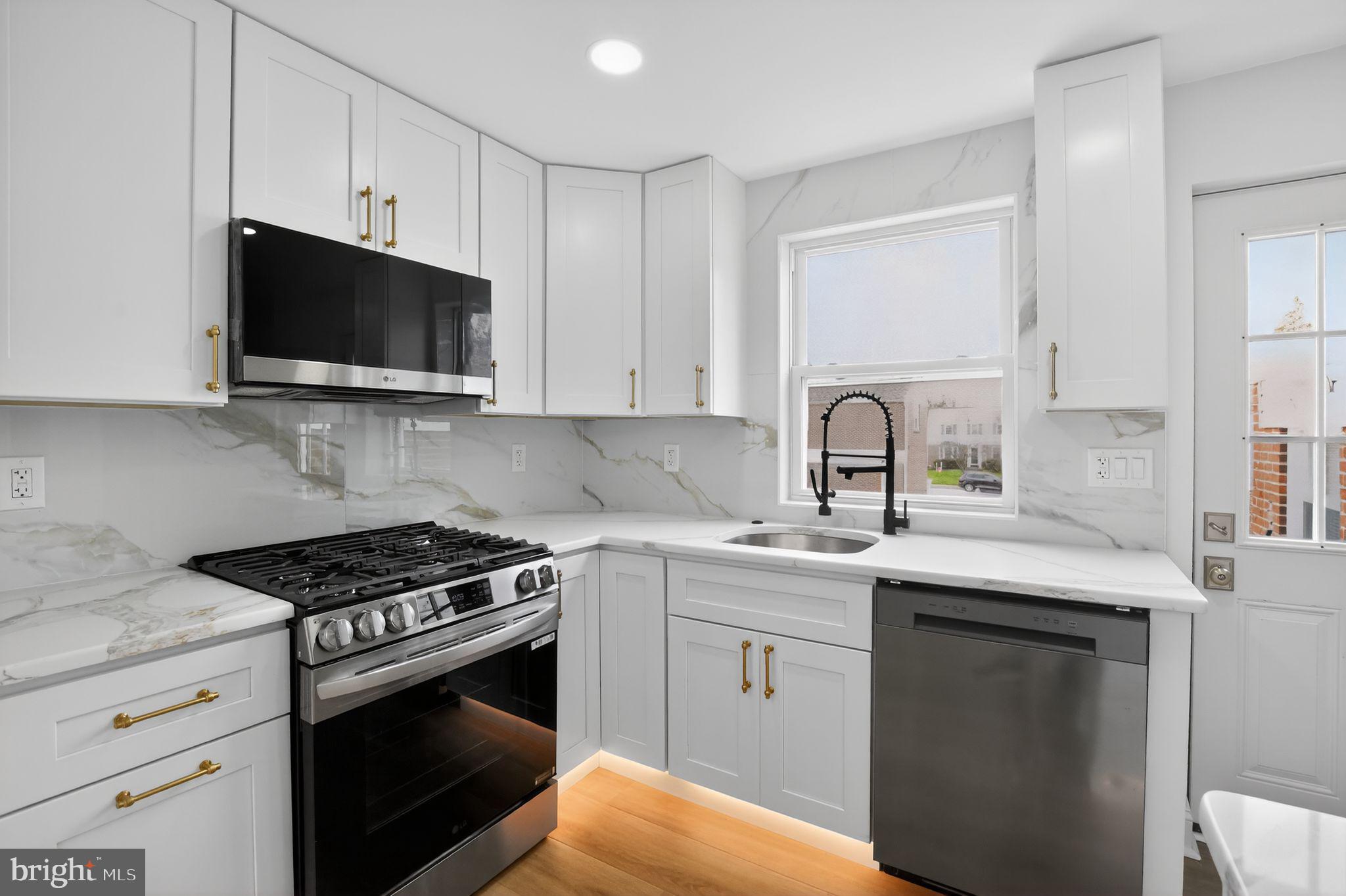 306 Brentwood Road Havertown, PA 19083 - Photo 5 of 48 a kitchen with stainless steel appliances a sink a stove a microwave and cabinets