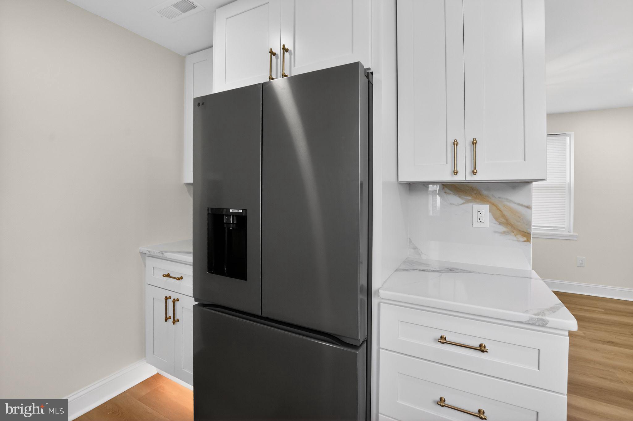 306 Brentwood Road Havertown, PA 19083 - Photo 7 of 48 a kitchen with a refrigerator and cabinets