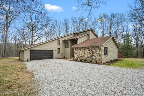 a living room with furniture a large window and a fireplace