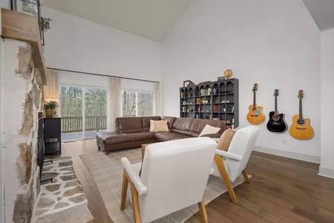a dining room with furniture a chandelier and wooden floor