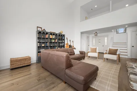 a dining room with furniture a chandelier and wooden floor
