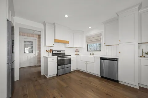 a bathroom with a sink a toilet and a mirror