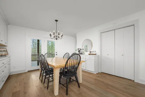 a bathroom with a sink a toilet a mirror and shower