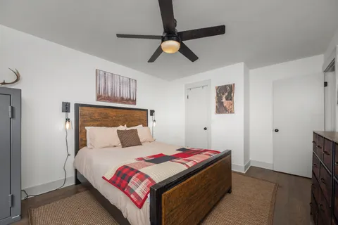 a bedroom with a bed and a chandelier