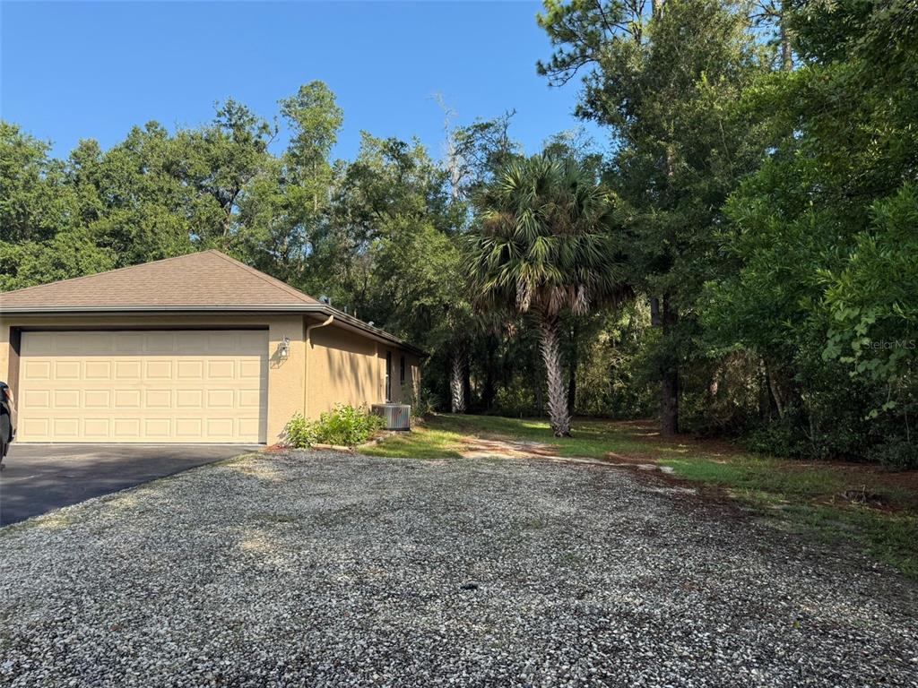 9735 West Dunnellon Road, Unit 31 Crystal River, FL 34428 - Photo 16 of 55 a backyard of a house with a yard and outdoor seating