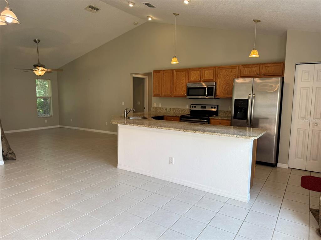 9735 West Dunnellon Road, Unit 31 Crystal River, FL 34428 - Photo 20 of 55 a kitchen with kitchen island a counter top space appliances and a window