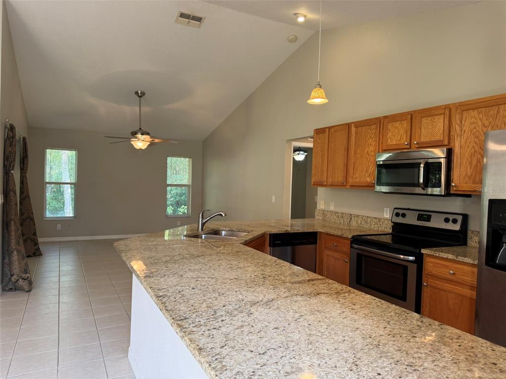 9735 West Dunnellon Road, Unit 31 Crystal River, FL 34428 - Photo 26 of 55 a kitchen with stainless steel appliances granite countertop a sink stove and refrigerator