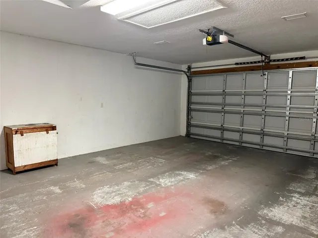 a kitchen with granite countertop a refrigerator a stove and a sink