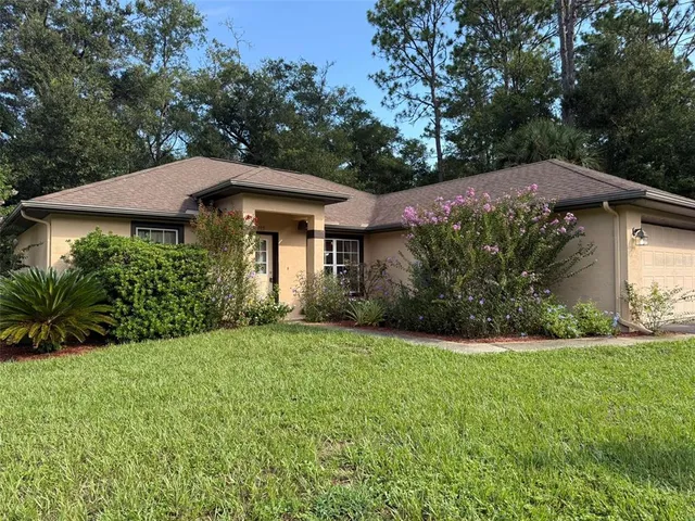 a view of a house with a yard and plants