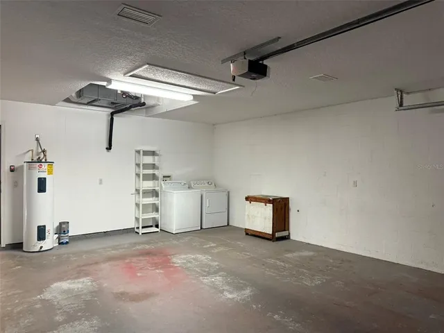 an empty room with windows and chandelier